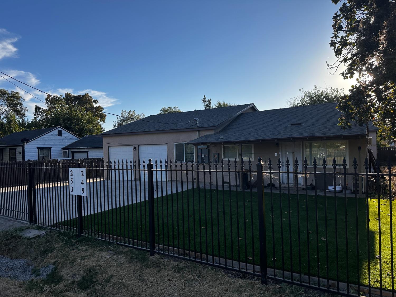 a view of a house with a wooden fence