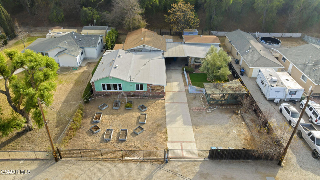 an aerial view of a house with a yard