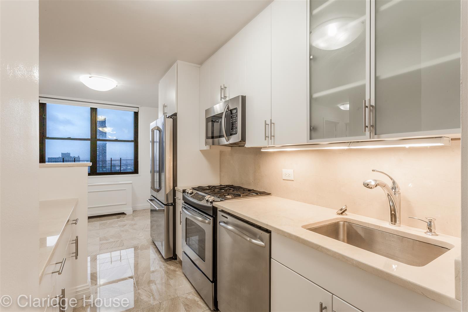 a kitchen that has a sink and a stove