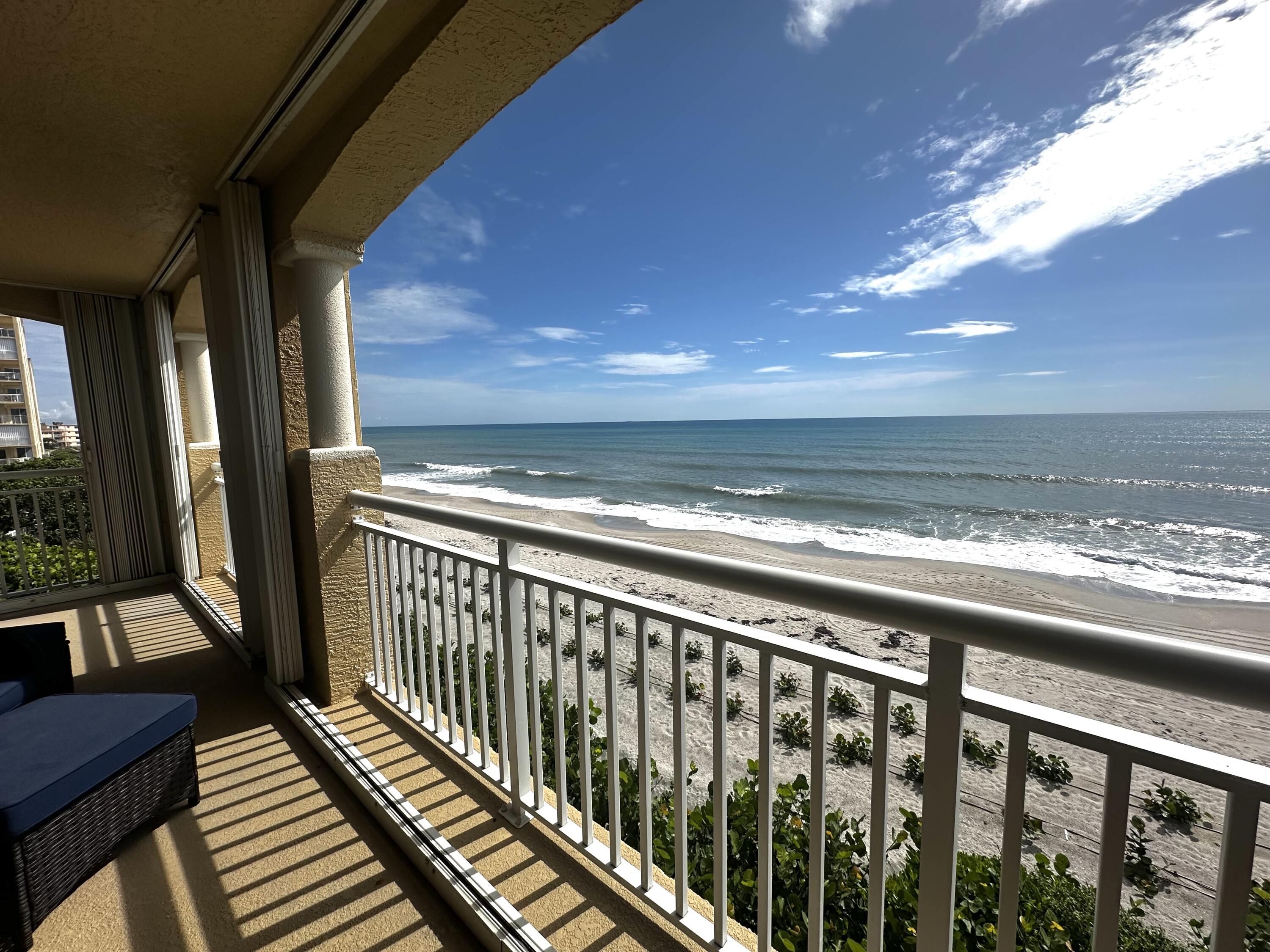 a view of a balcony with wooden floor and outdoor space