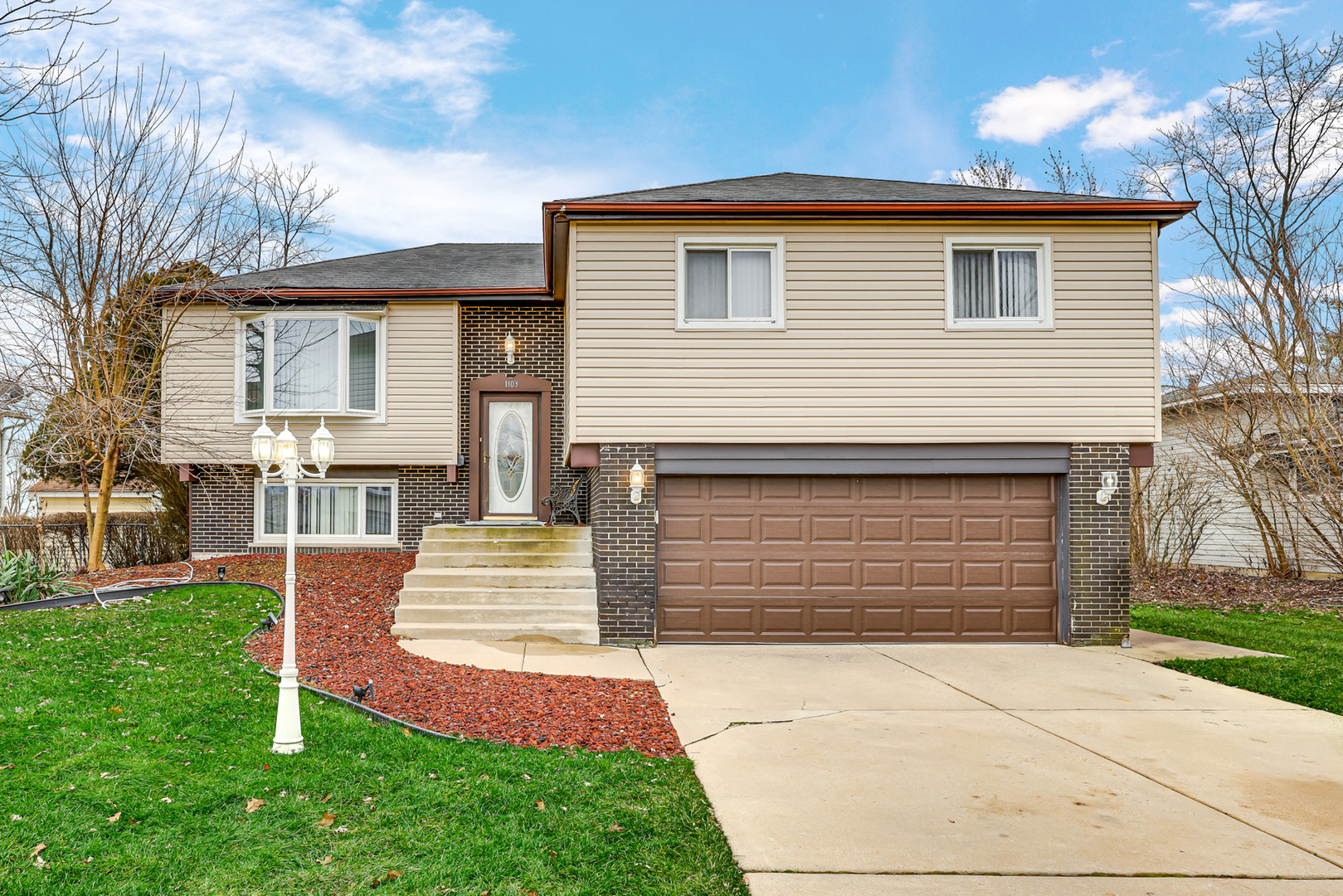 a front view of a house with a yard and garage