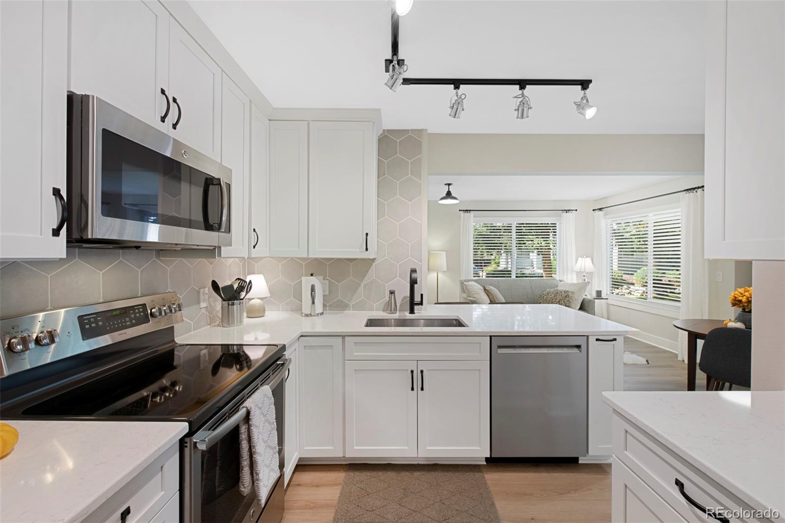 a kitchen with a sink stove and microwave