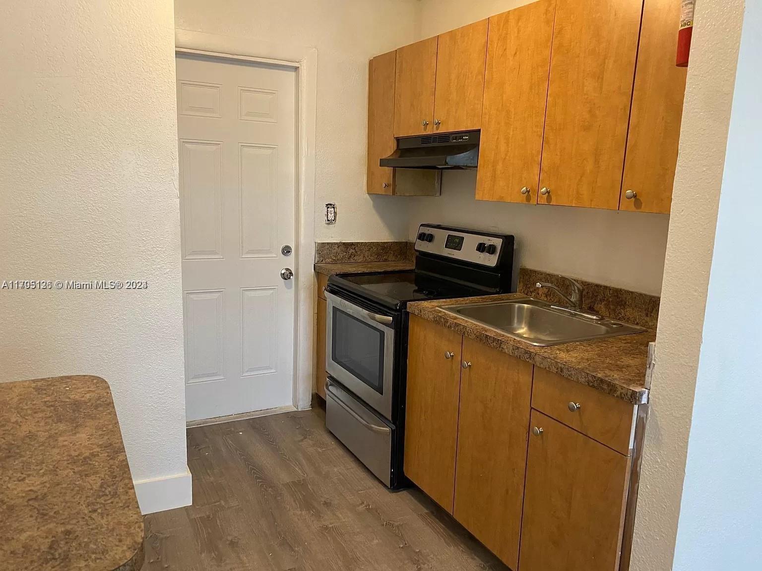 a view of a kitchen with stove top oven