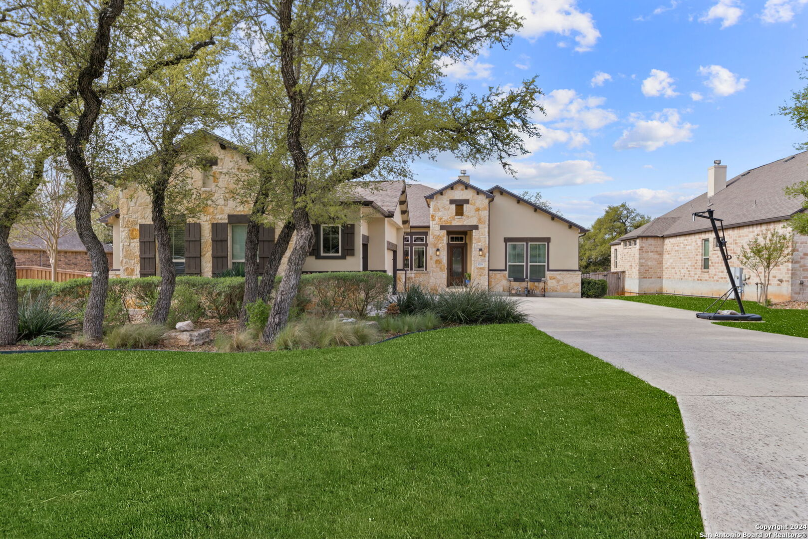 a front view of a house with a garden and yard