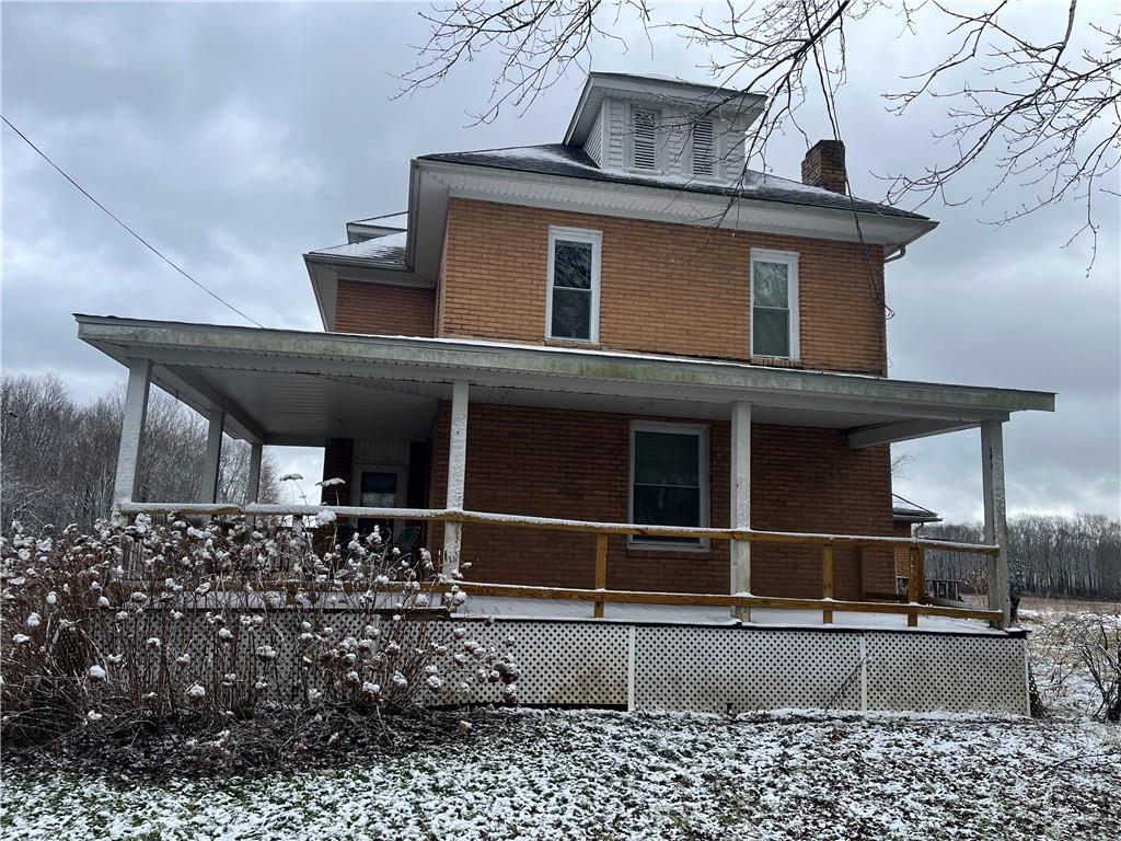 a view of a house with a window and wooden fence