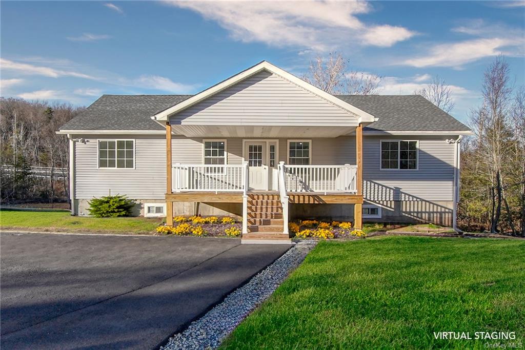 View of front facade with a front lawn -  staged