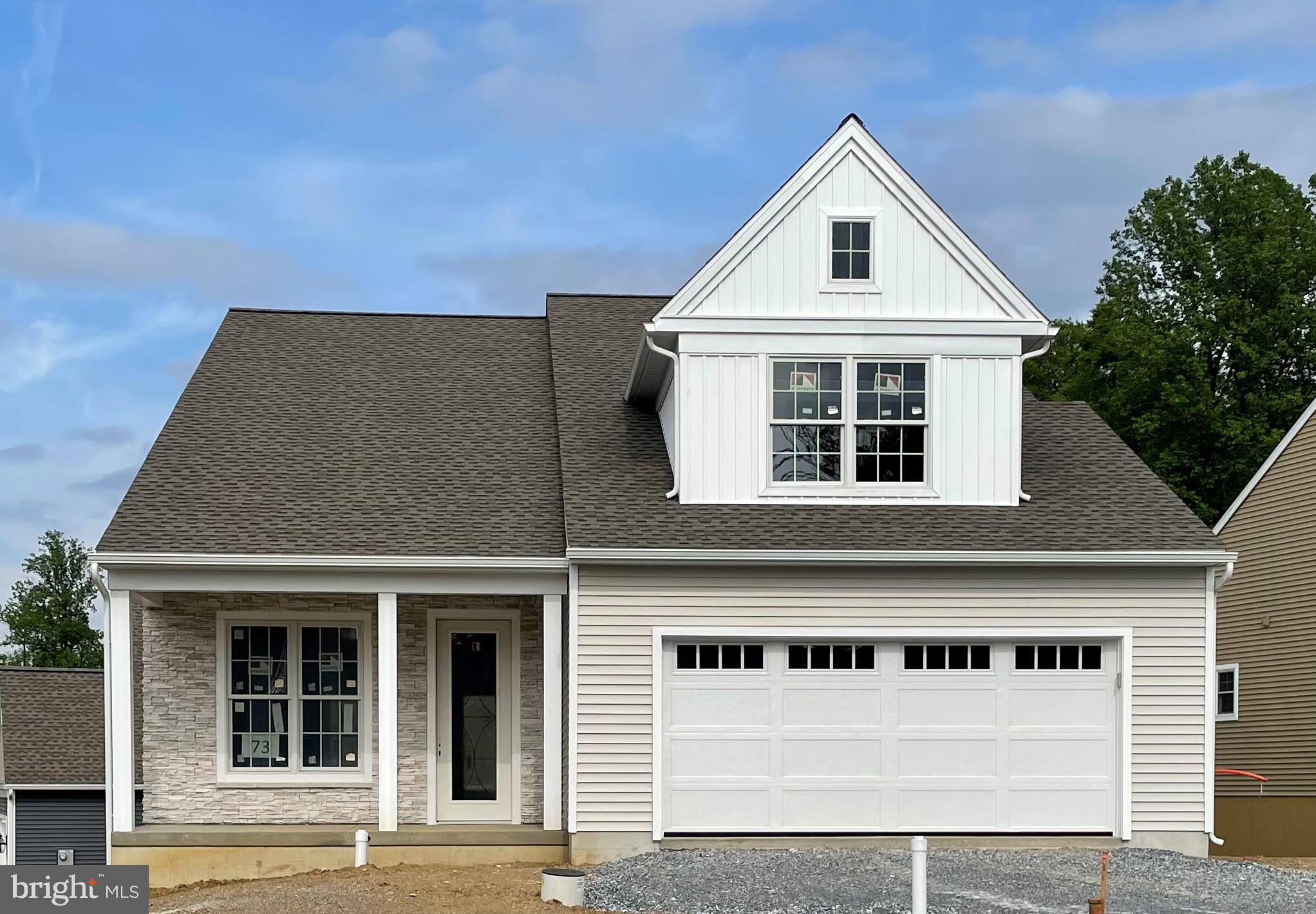 a front view of a house with a garage and balcony