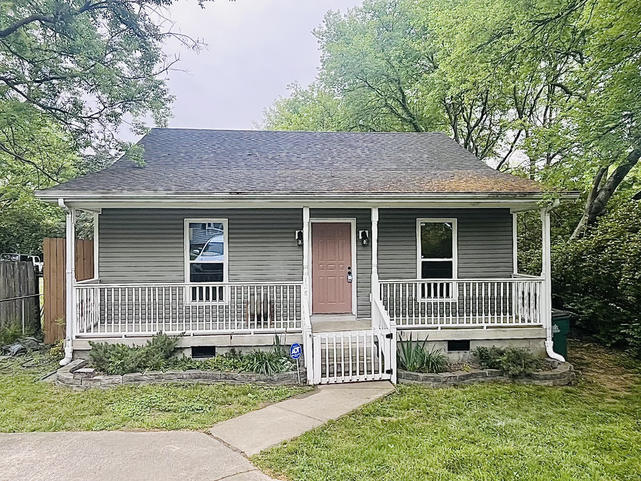 a front view of a house with a garden