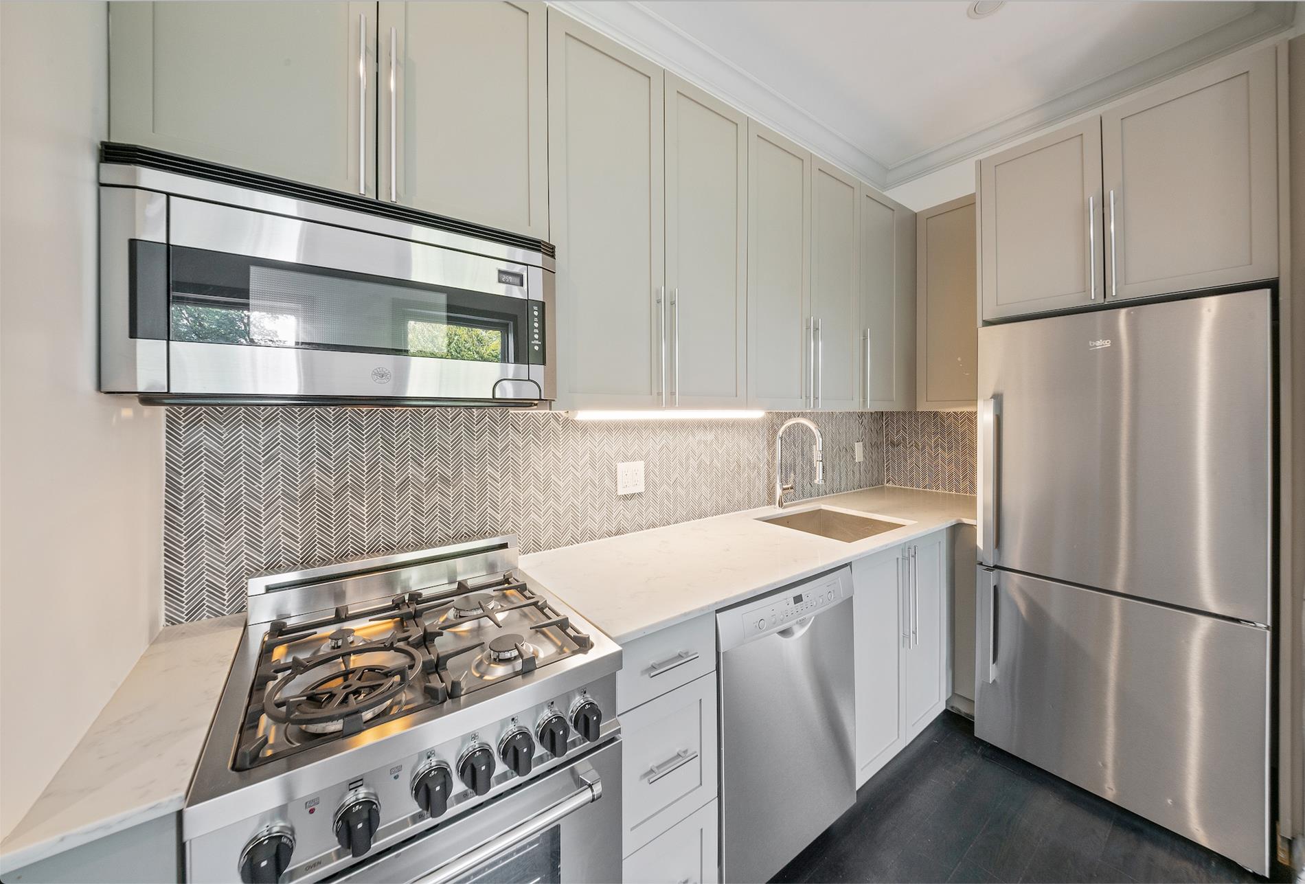 a kitchen with a stove and a refrigerator