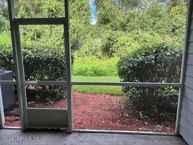 a view of a chair and floor to ceiling window