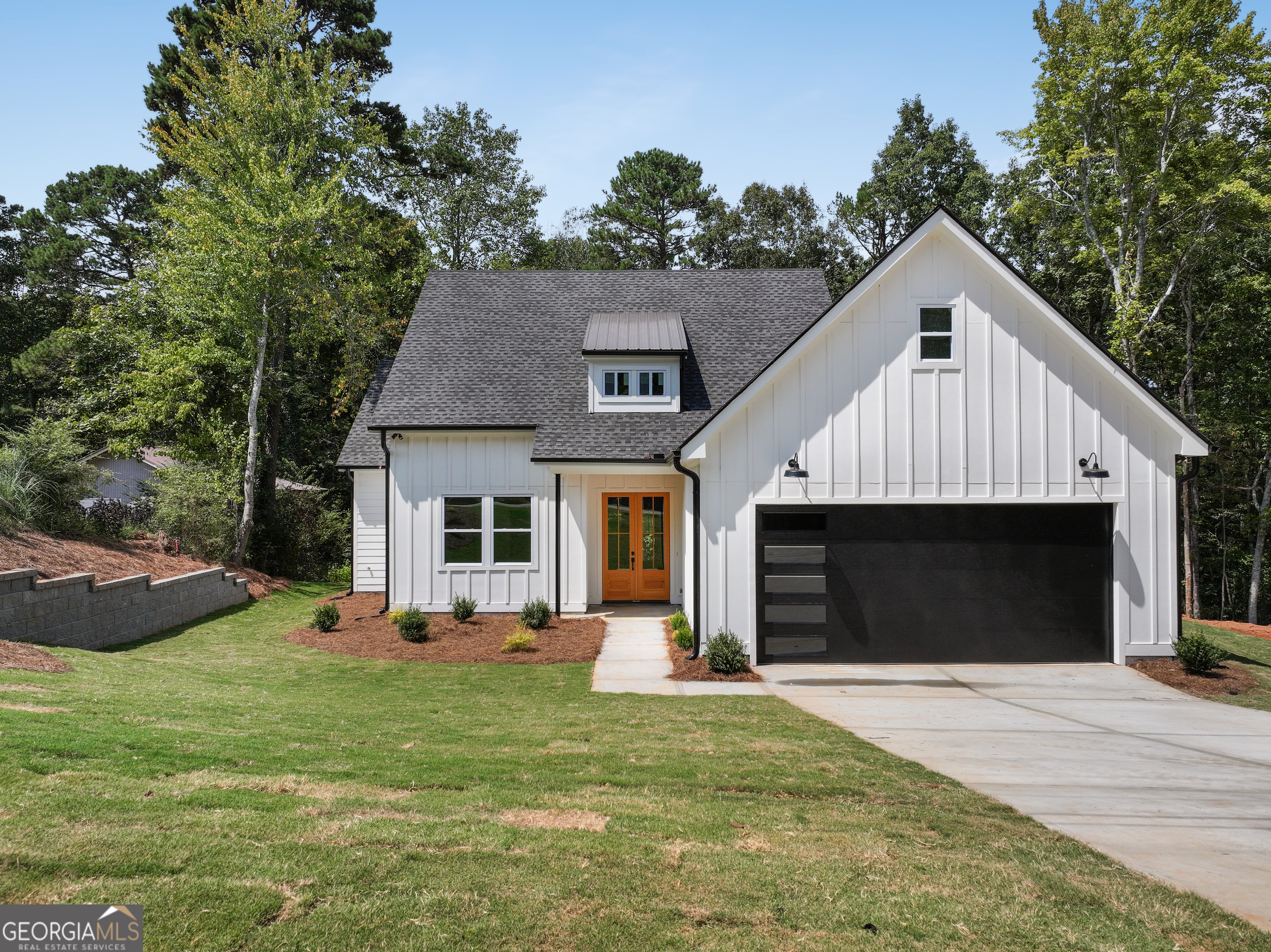 a front view of a house with a yard and entertaining space