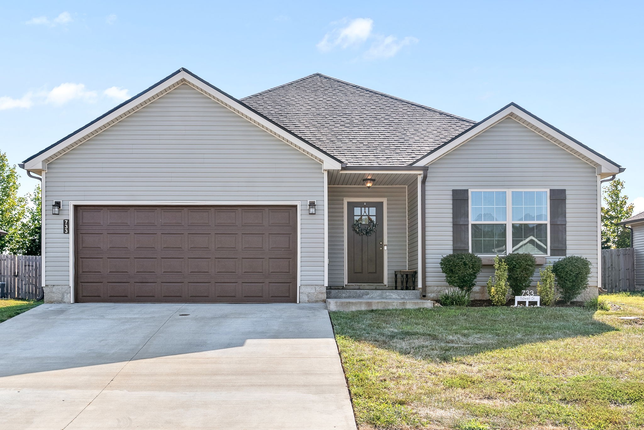 a front view of a house and garage