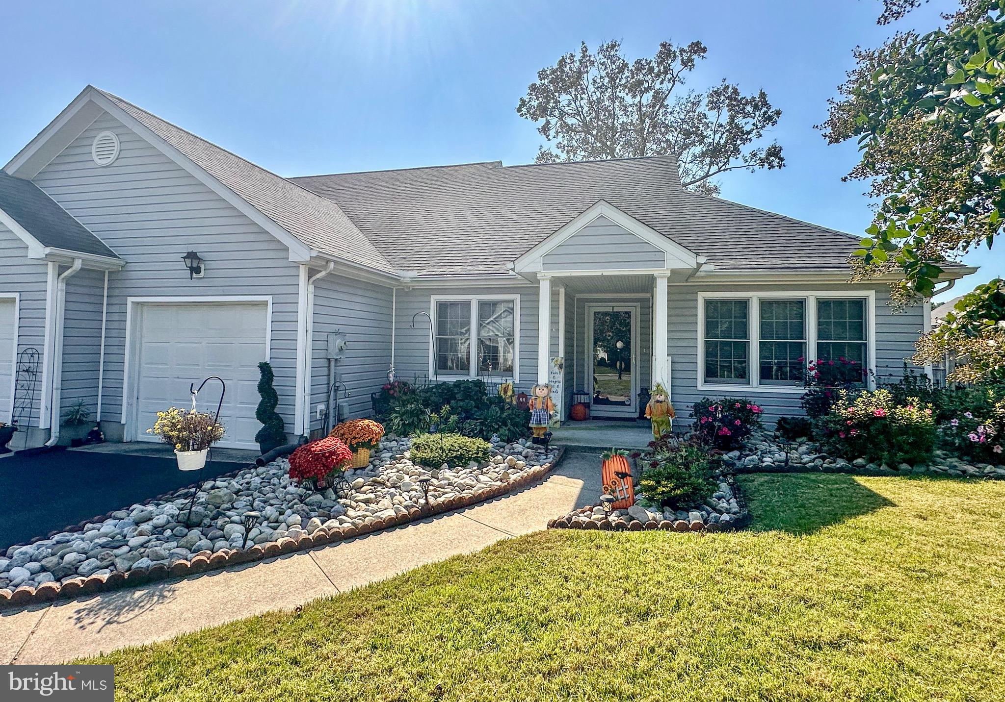 a front view of a house with garden and porch