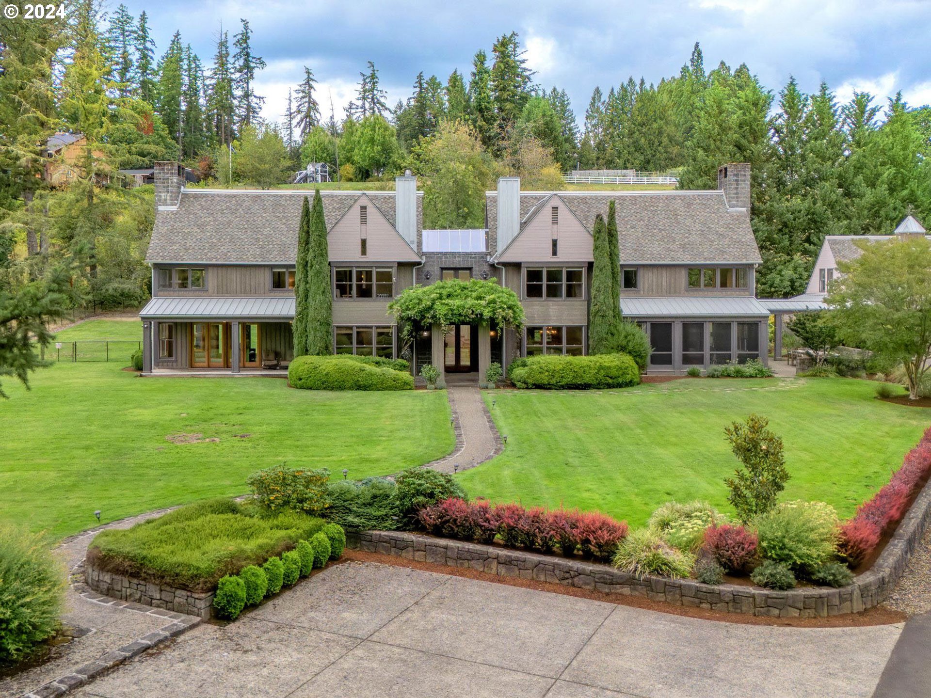 a front view of a house with a garden