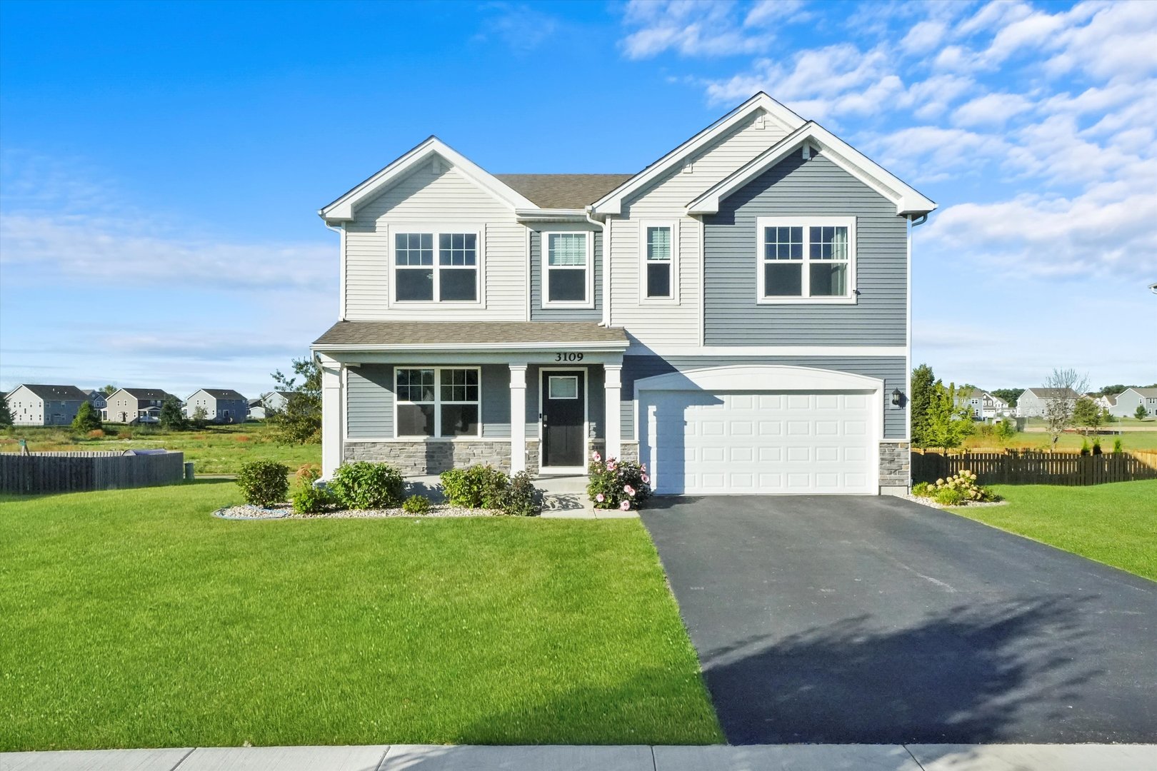 a front view of a house with a yard and garage