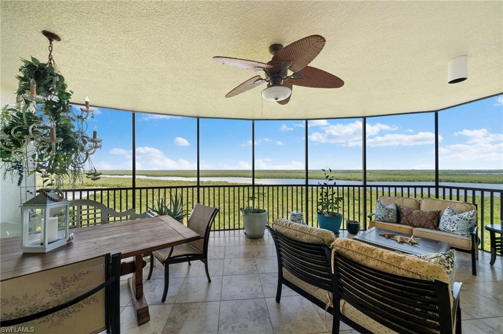 Sunroom featuring a water view, ceiling fan, and a healthy amount of sunlight