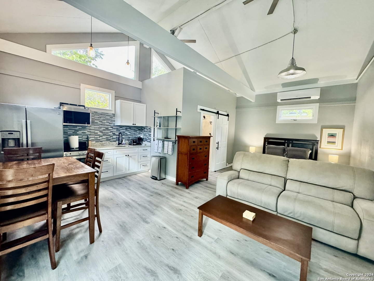 a living room with furniture and kitchen view