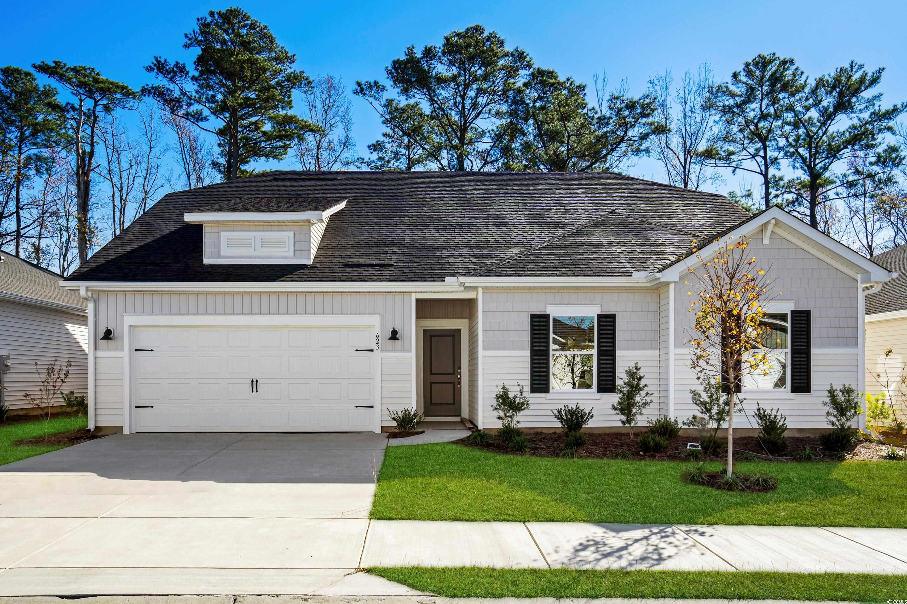 View of front of house with a garage and a front l