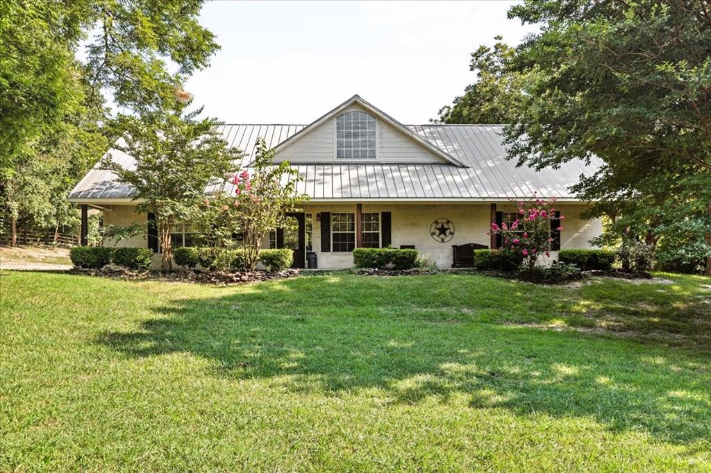 a front view of a house with a garden and porch