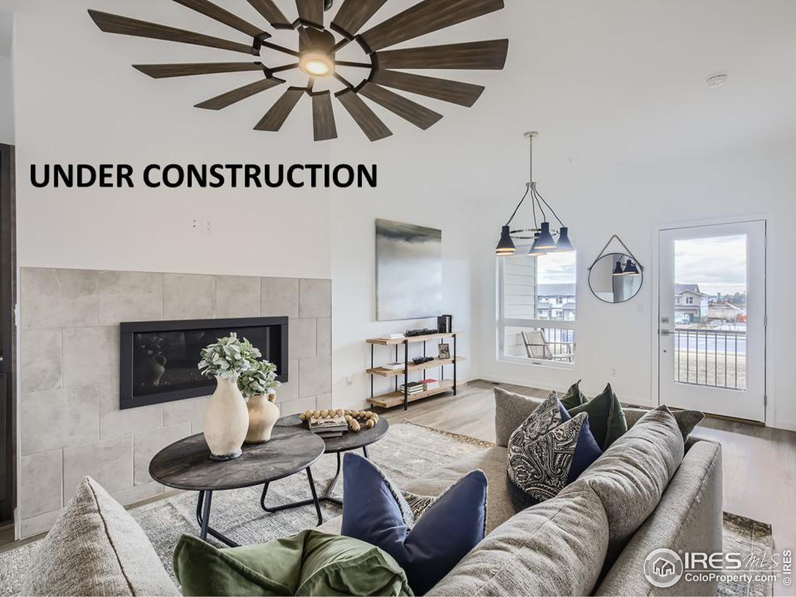 a living room with furniture a fireplace and a chandelier