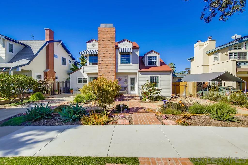 a front view of multiple houses with yard