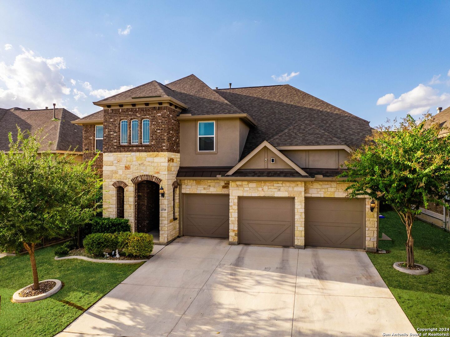 a front view of a house with a yard and garage