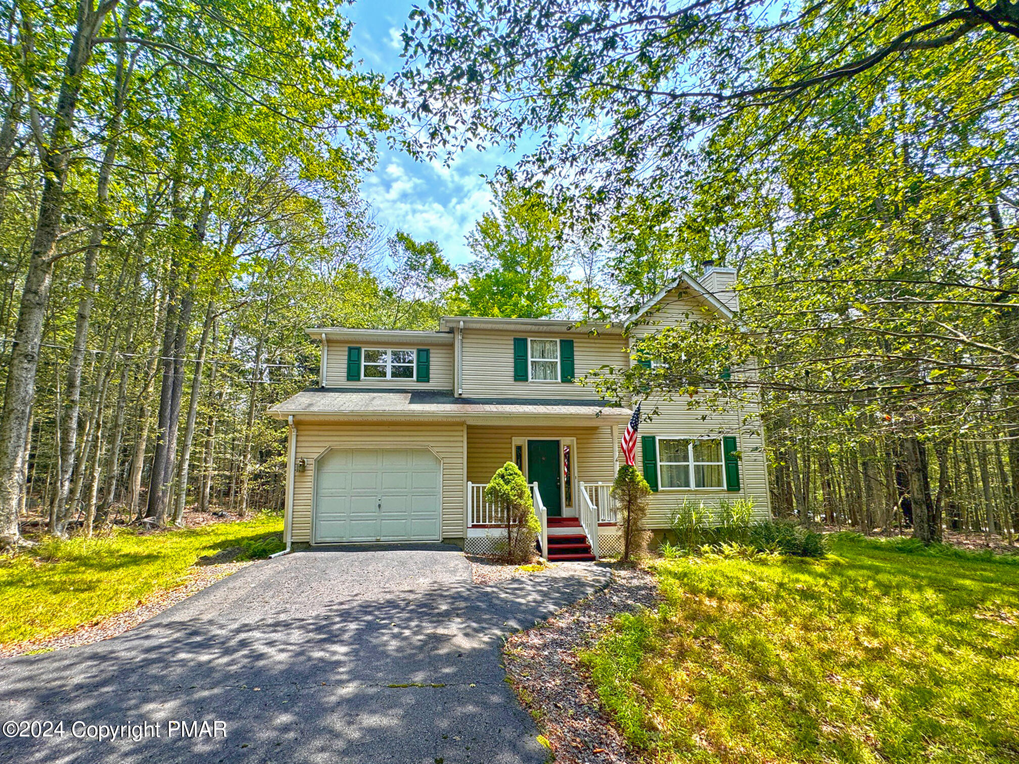 a view of a house with a patio and a yard