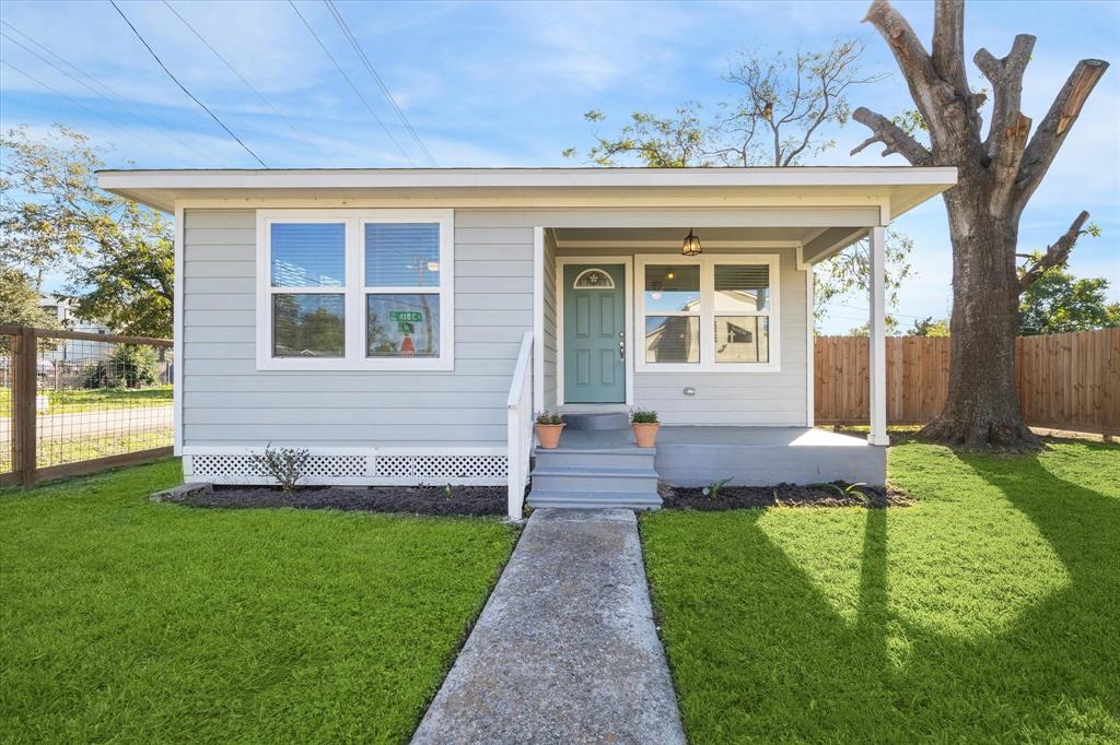 a front view of a house with a yard and an outdoor seating