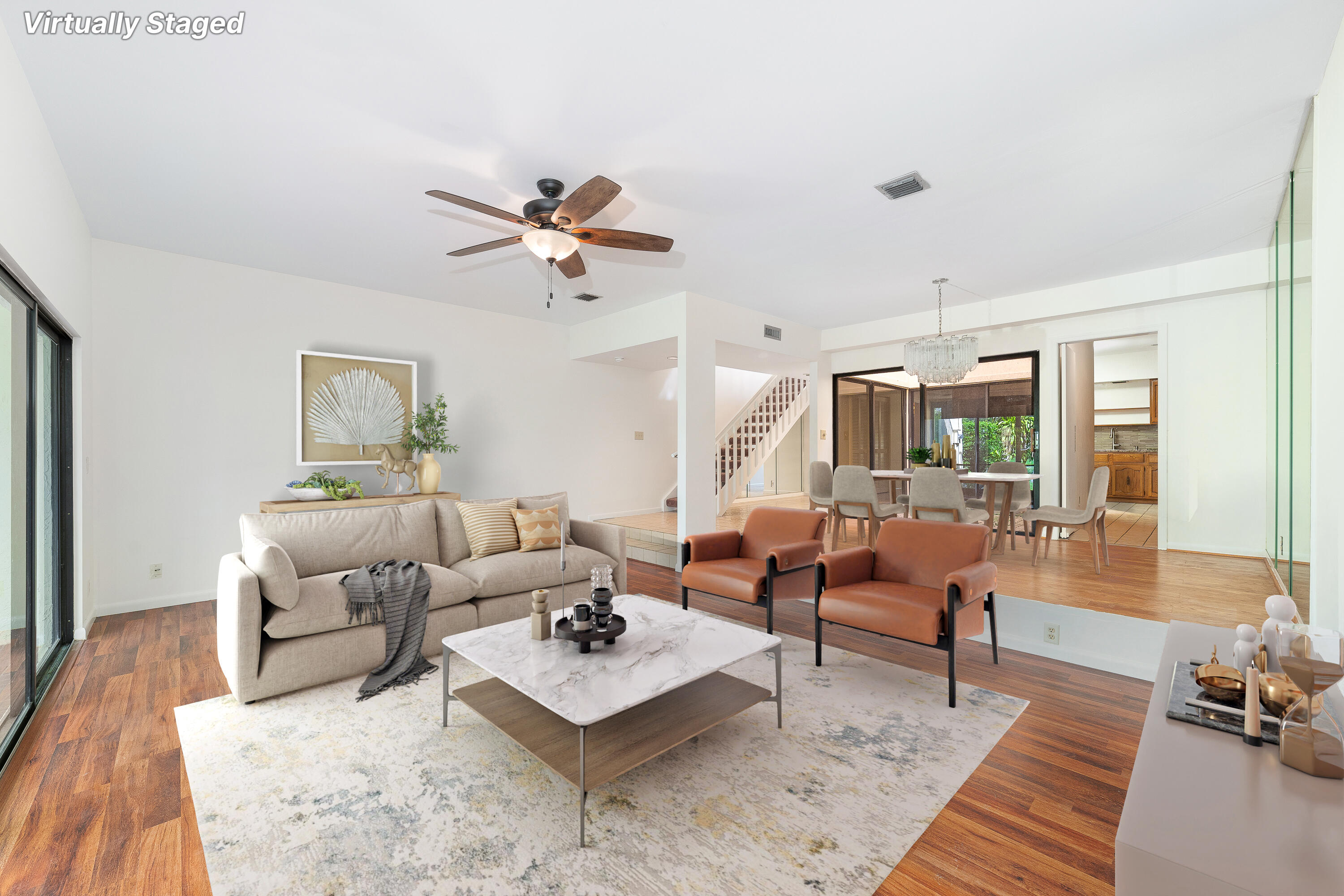 a living room with furniture rug and wooden floor