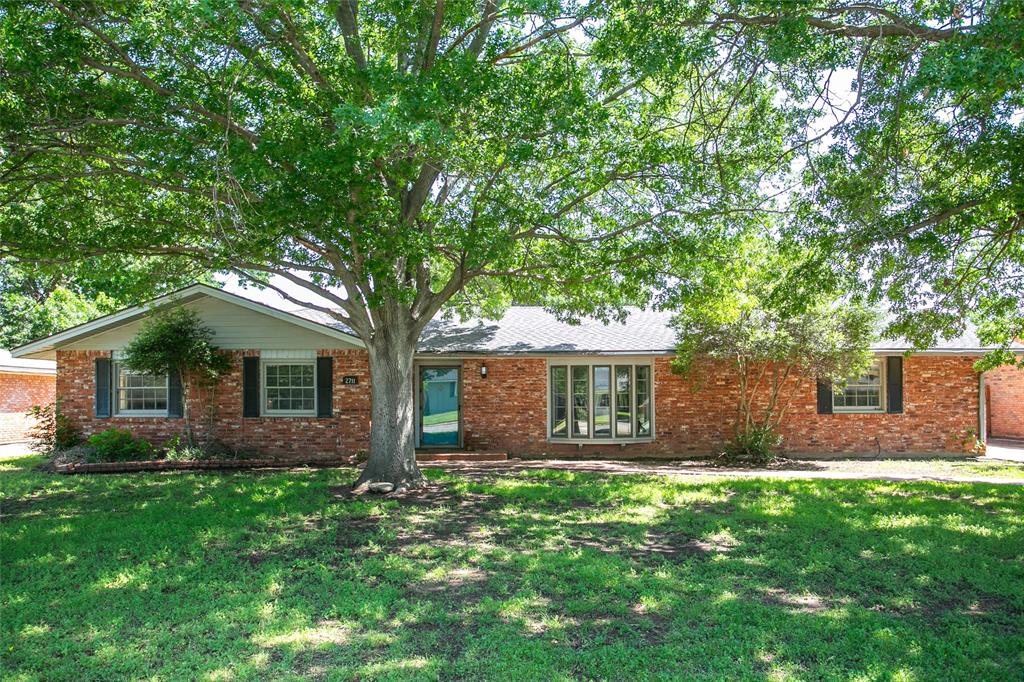 a front view of house with yard and green space