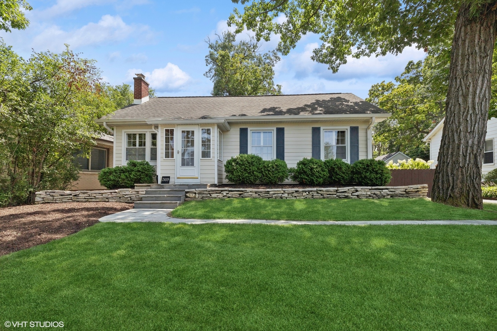 a front view of house with yard and green space