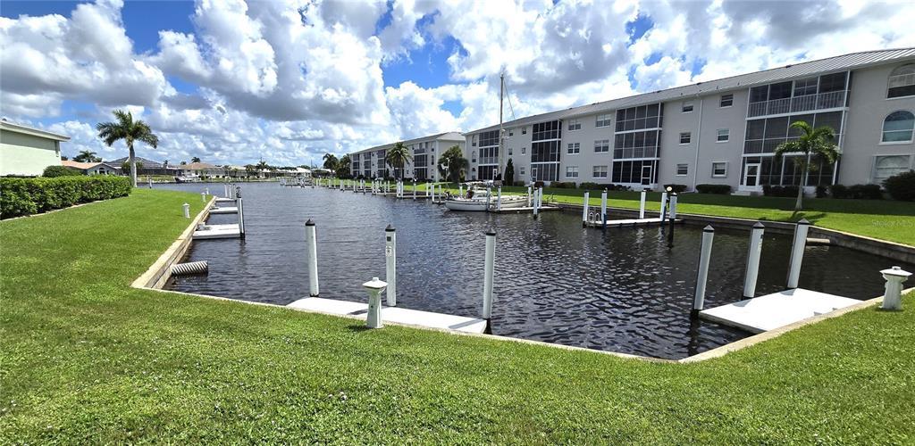 a view of a house with a yard from a lake view