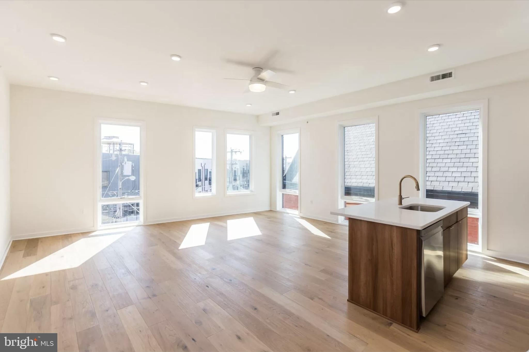 a view of kitchen with sink and wooden floor