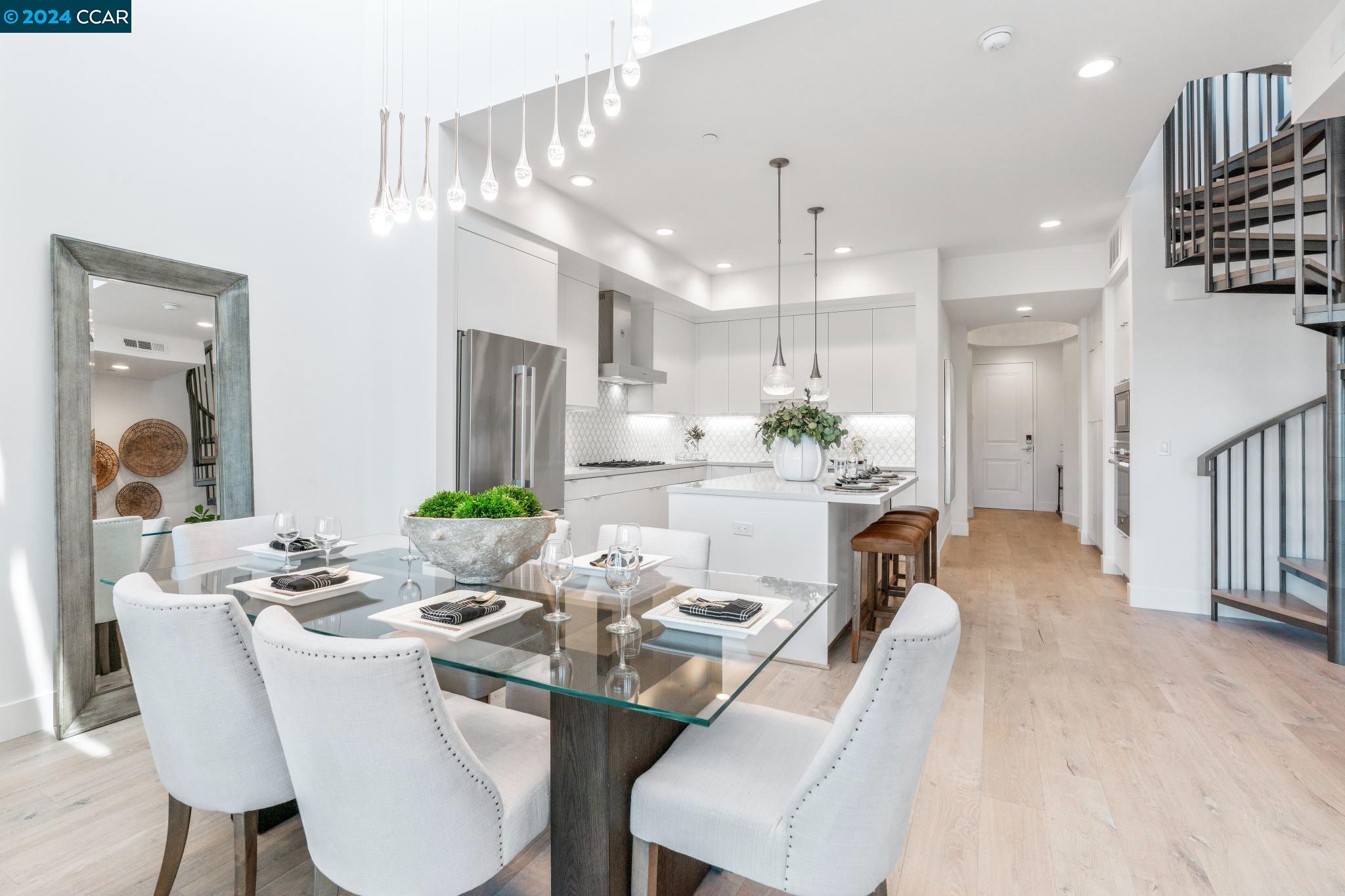 a dining room with furniture and a chandelier