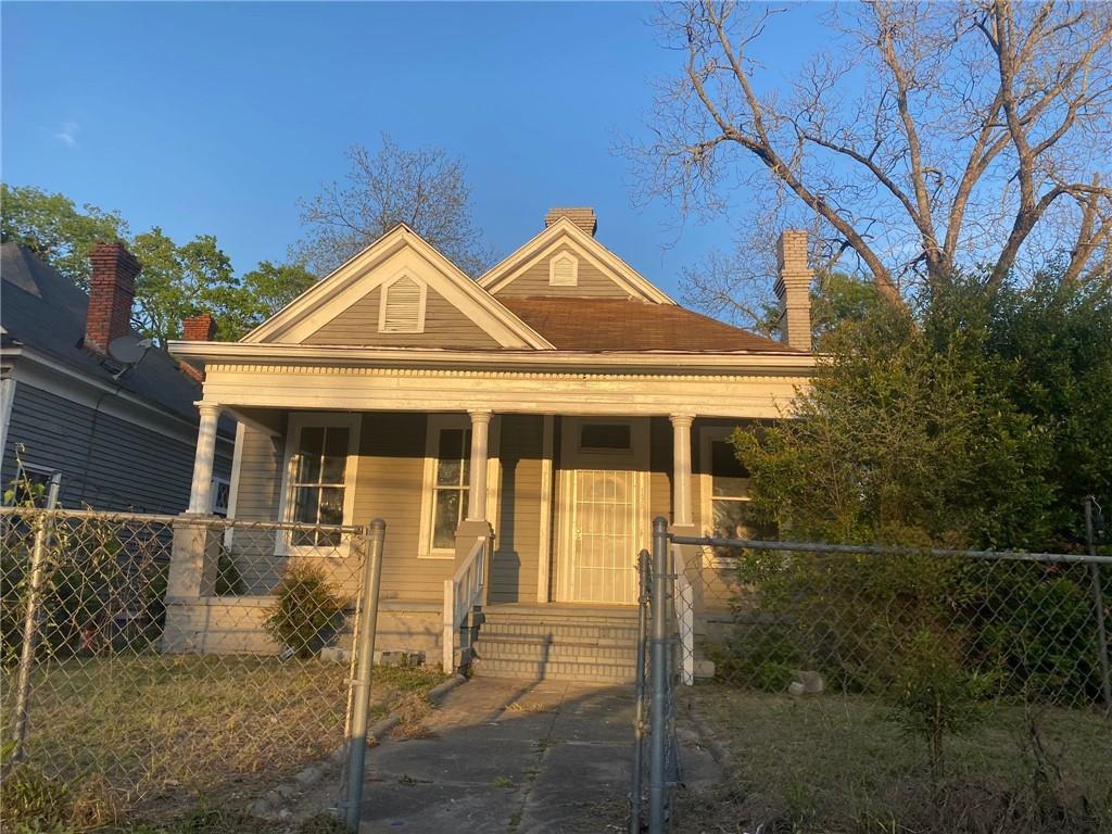 a front view of a house with a garden and yard