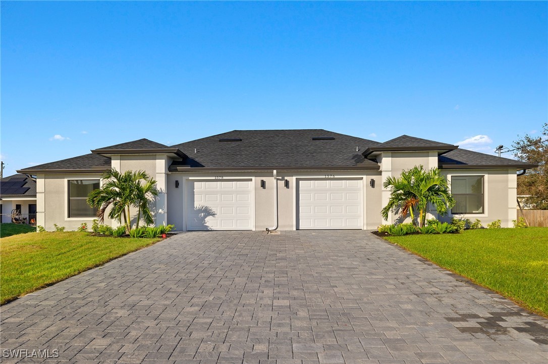 a front view of a house with a yard and garage