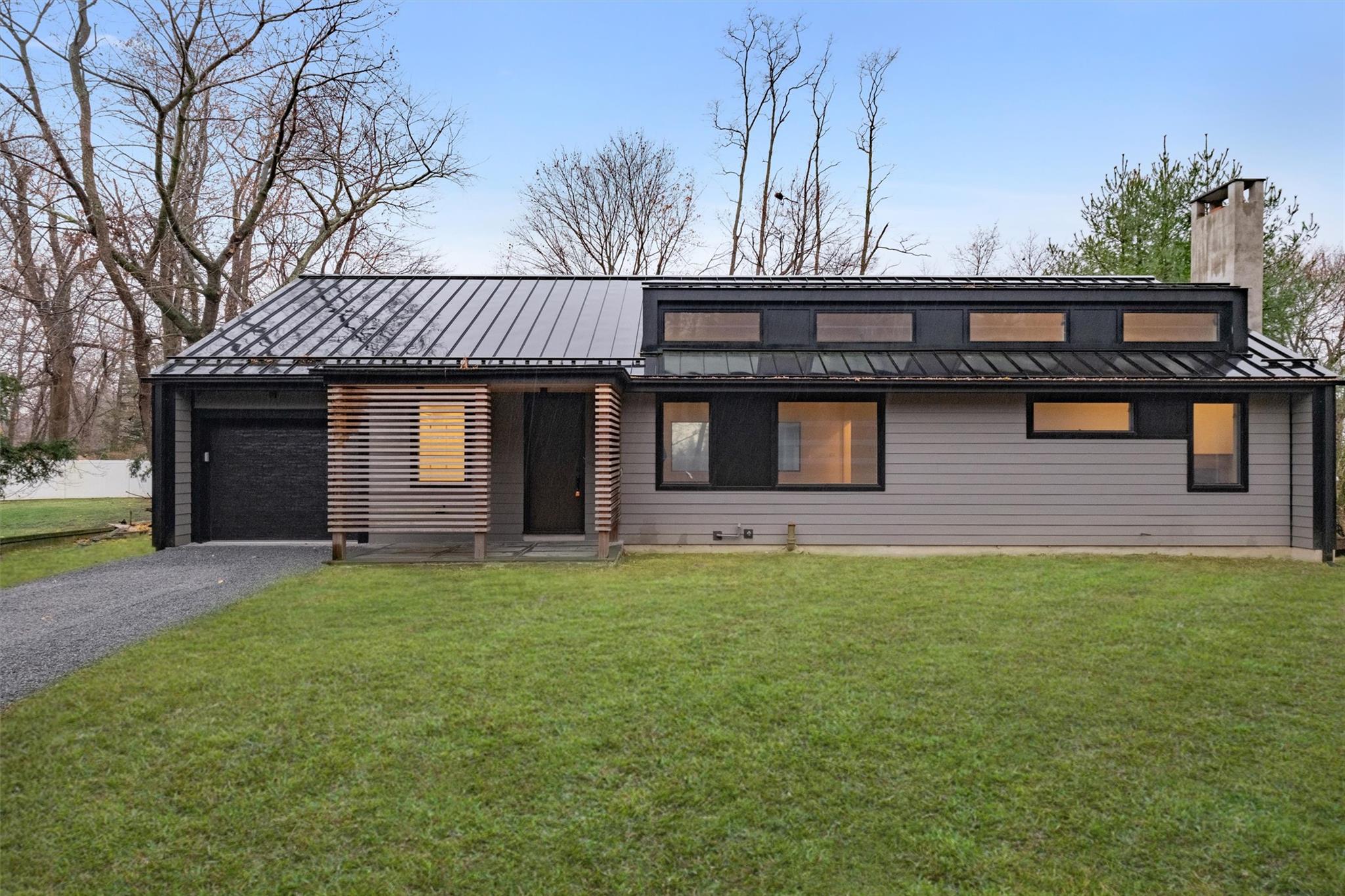 View of front of house featuring a front yard and a garage