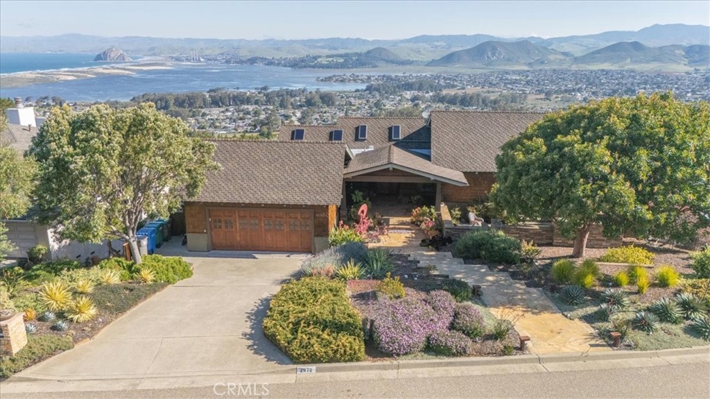 an aerial view of a house with a yard and lake view