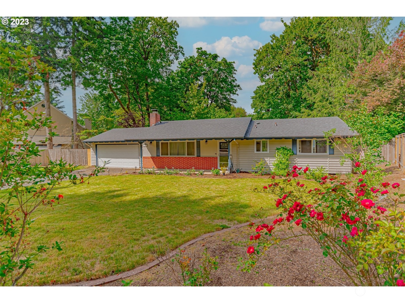 a view of a house with a big yard and potted plants