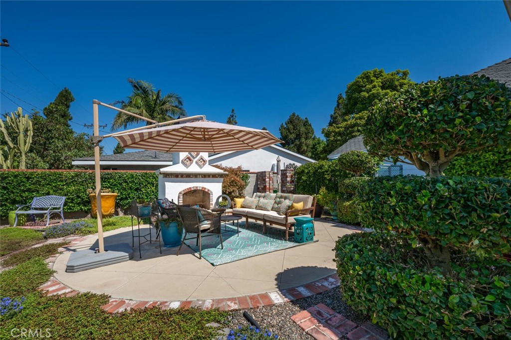 a view of a patio with a table and chairs under an umbrella