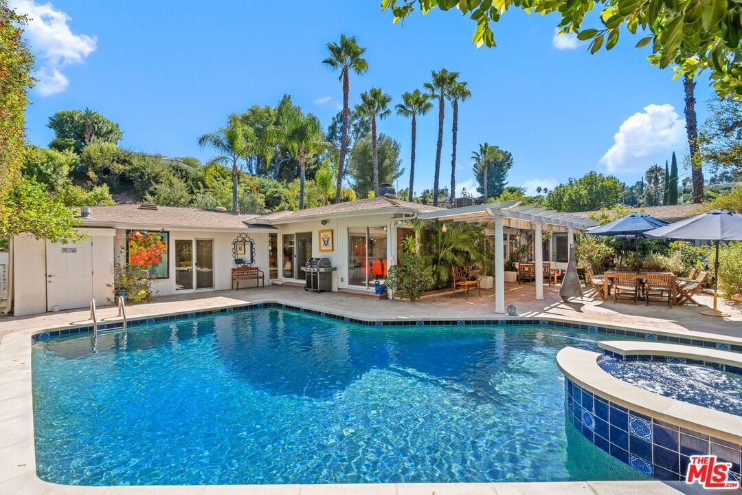 swimming pool view with a seating space