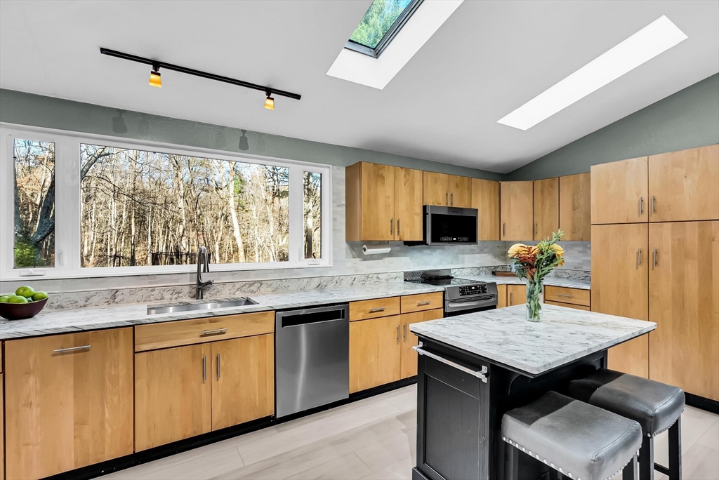 a kitchen with a sink stove and refrigerator