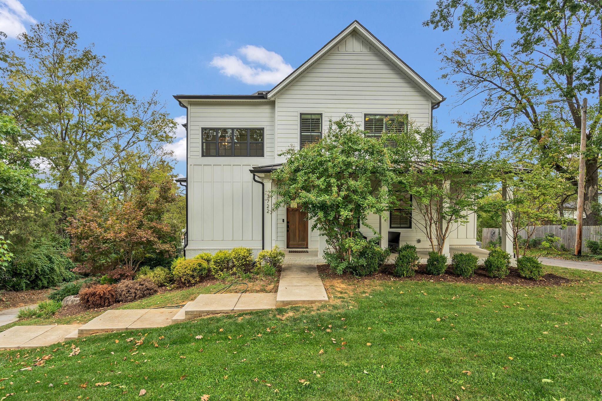 a front view of house with yard and trees around