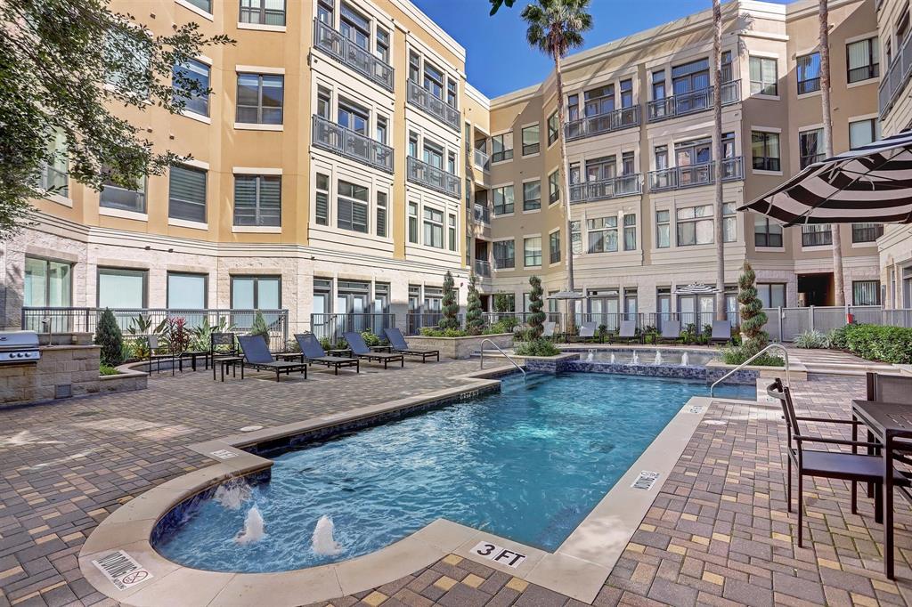 a view of a brick building with swimming pool