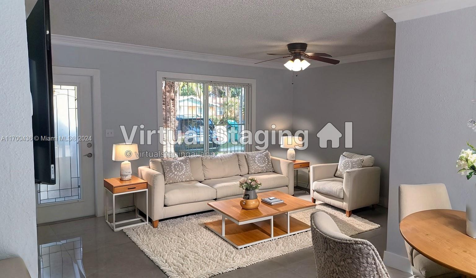 a living room with furniture a chandelier and a window