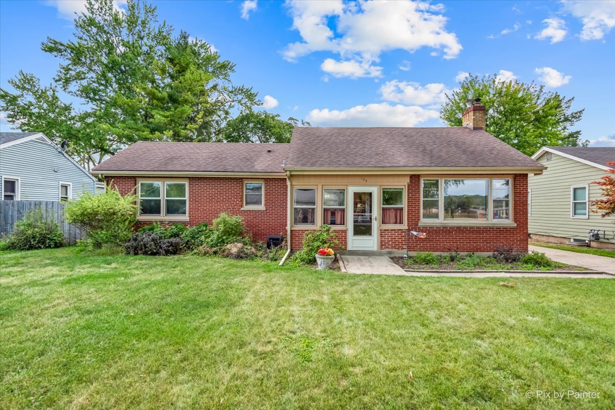 a front view of a house with a yard and porch