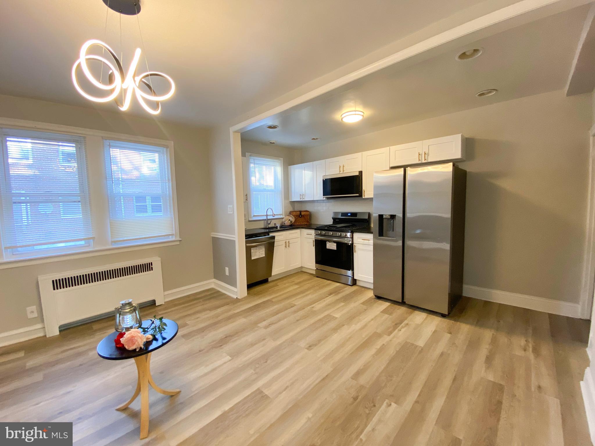 a kitchen with stainless steel appliances granite countertop a refrigerator and microwave