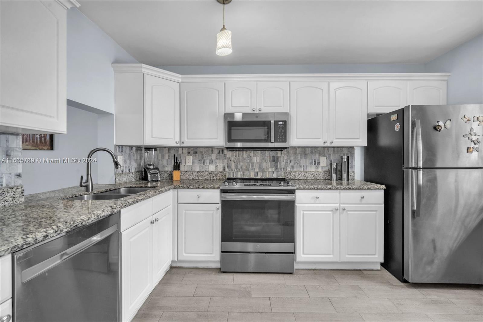 a kitchen with a sink stove and refrigerator