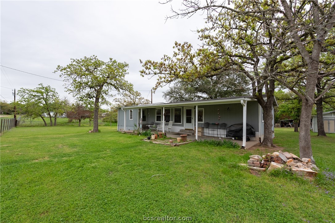 a front view of a house with garden and trees