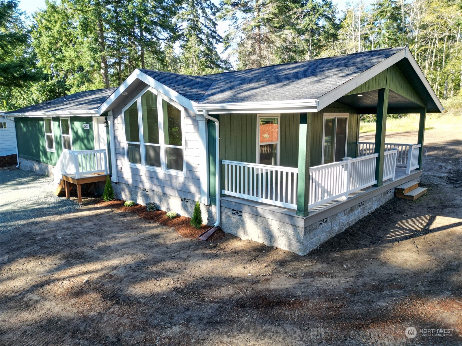 a view of a house with a yard and deck